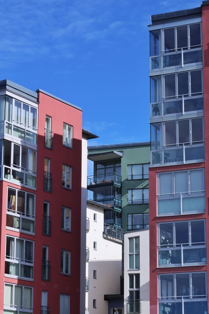 mission-02 Colorful modern apartment buildings against a clear blue sky in Stockholm, Sweden.